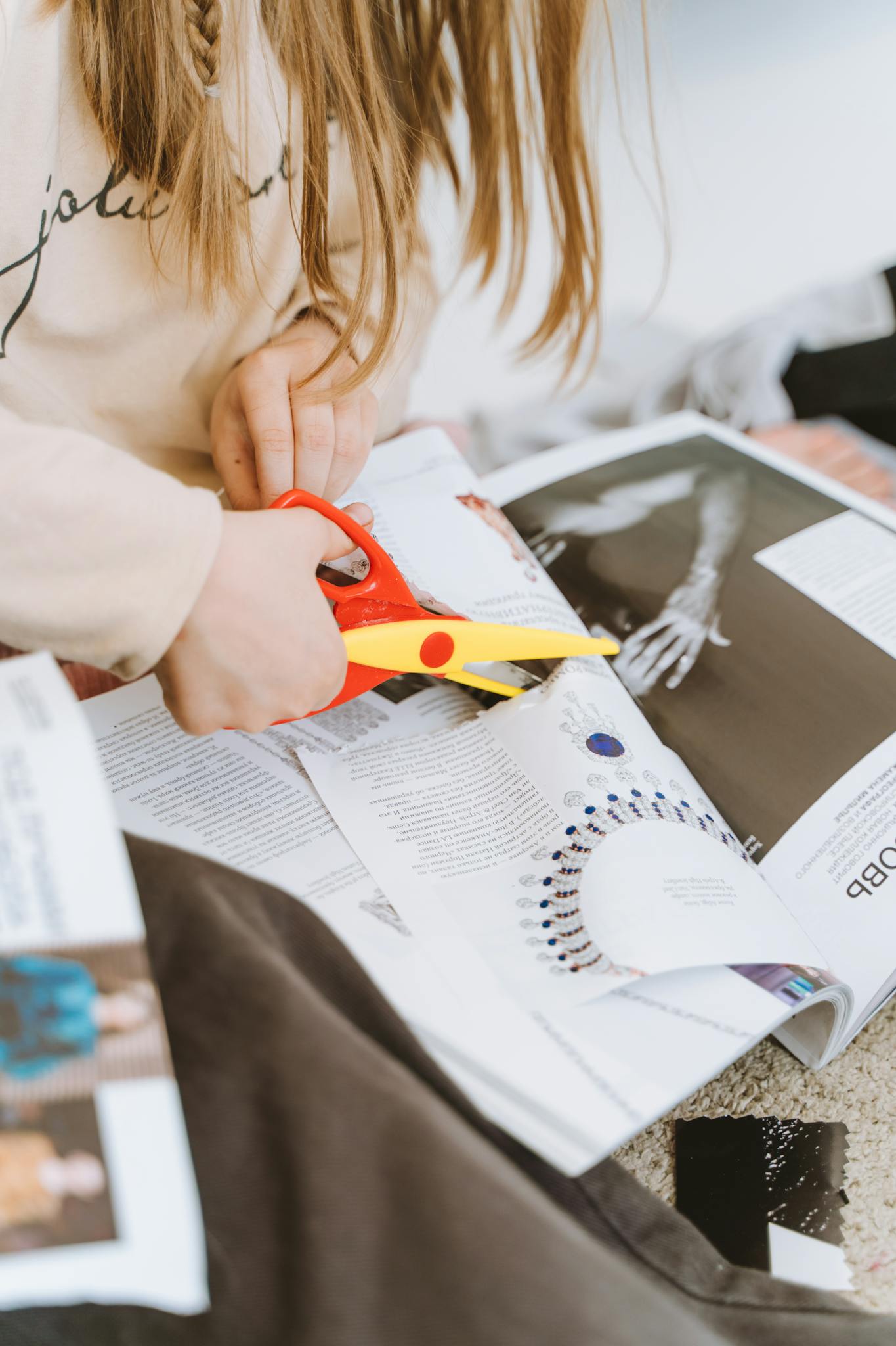 close up of a person cutting magazine pages